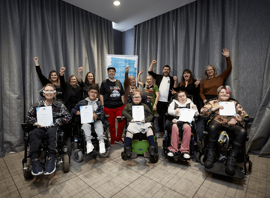 A group of people in wheelchairs posing for a photo