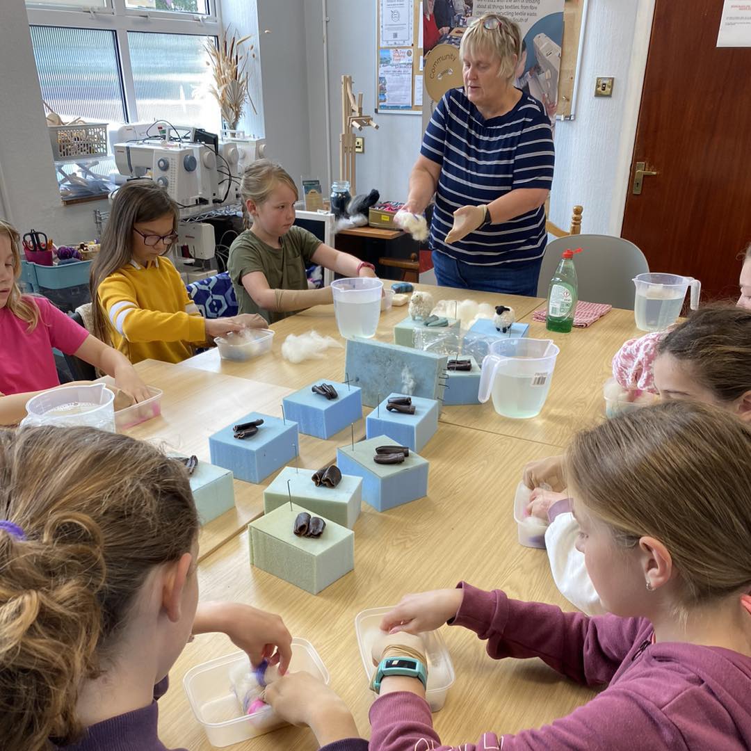 Children learning at the yarning workshop